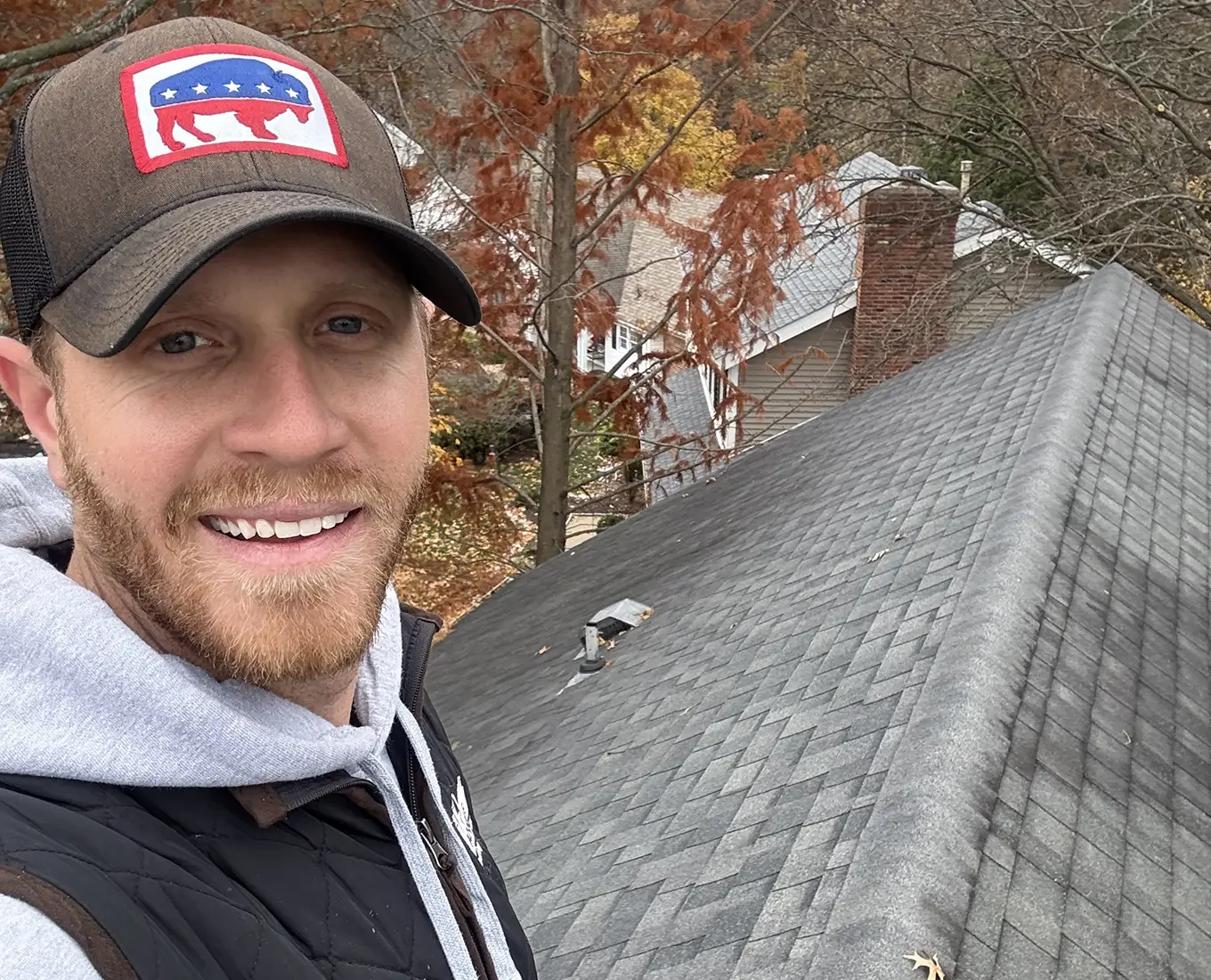 tanner on top of roof working roof repair in st. louis mo