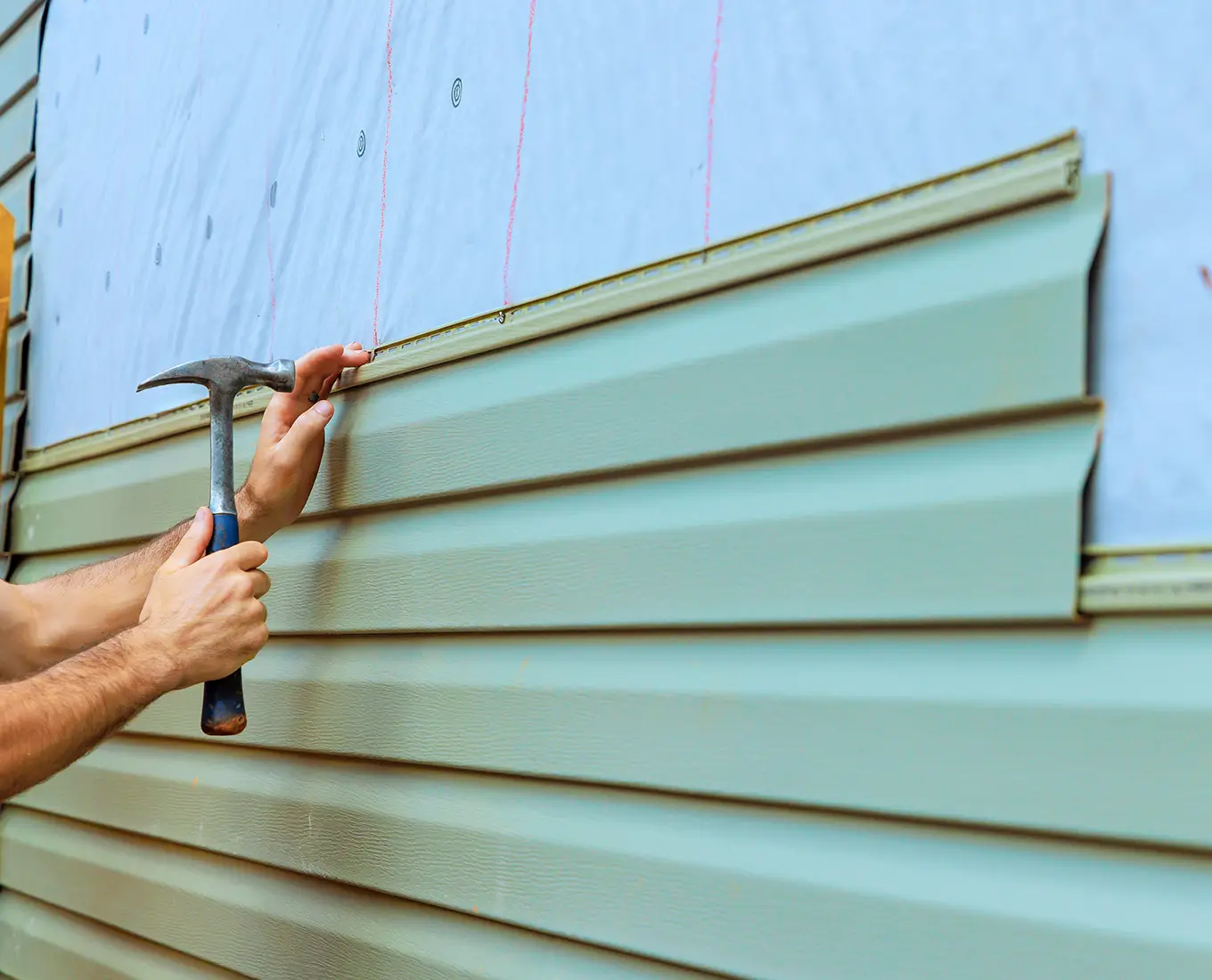 Contractor is installing new siding on house exterior in st louis mo
