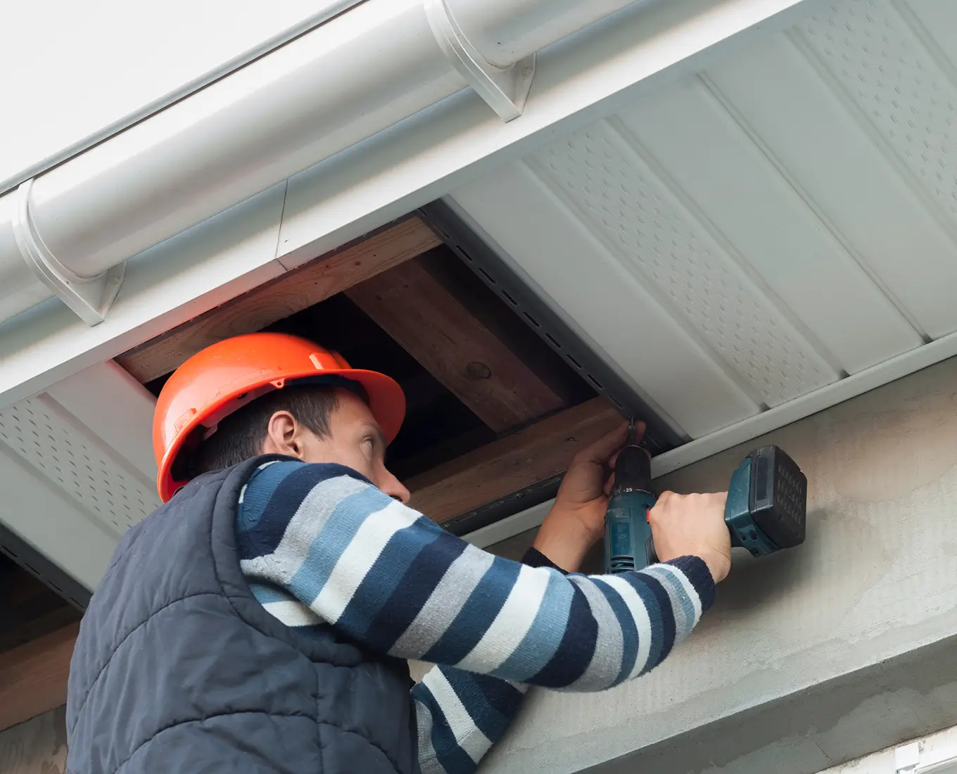 worker installing soffits on house in st louis mo