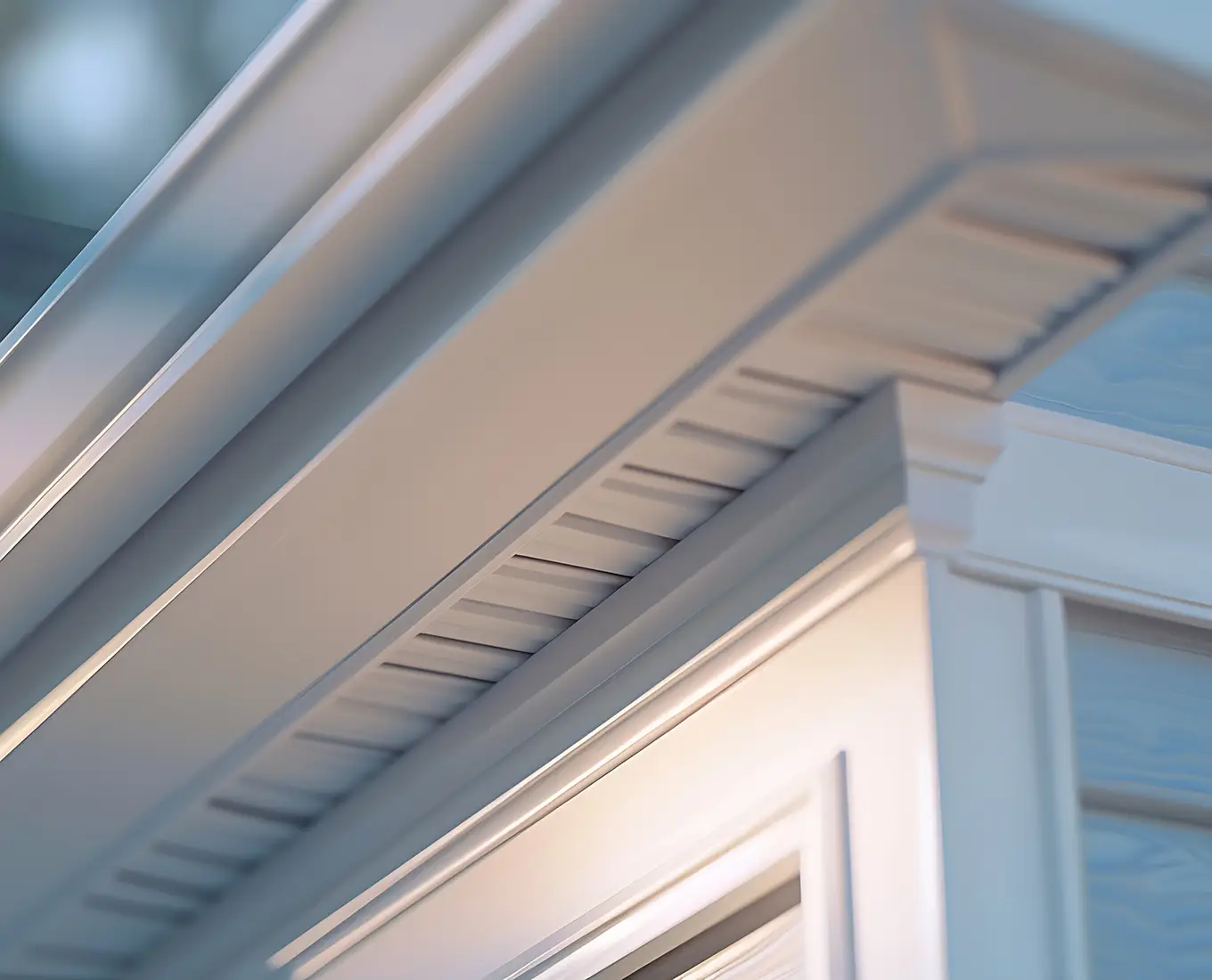 white frame gutter guard system eaves through fascia drip edge colonial white soffit with ventilation brick facade siding on a family home st louis mo