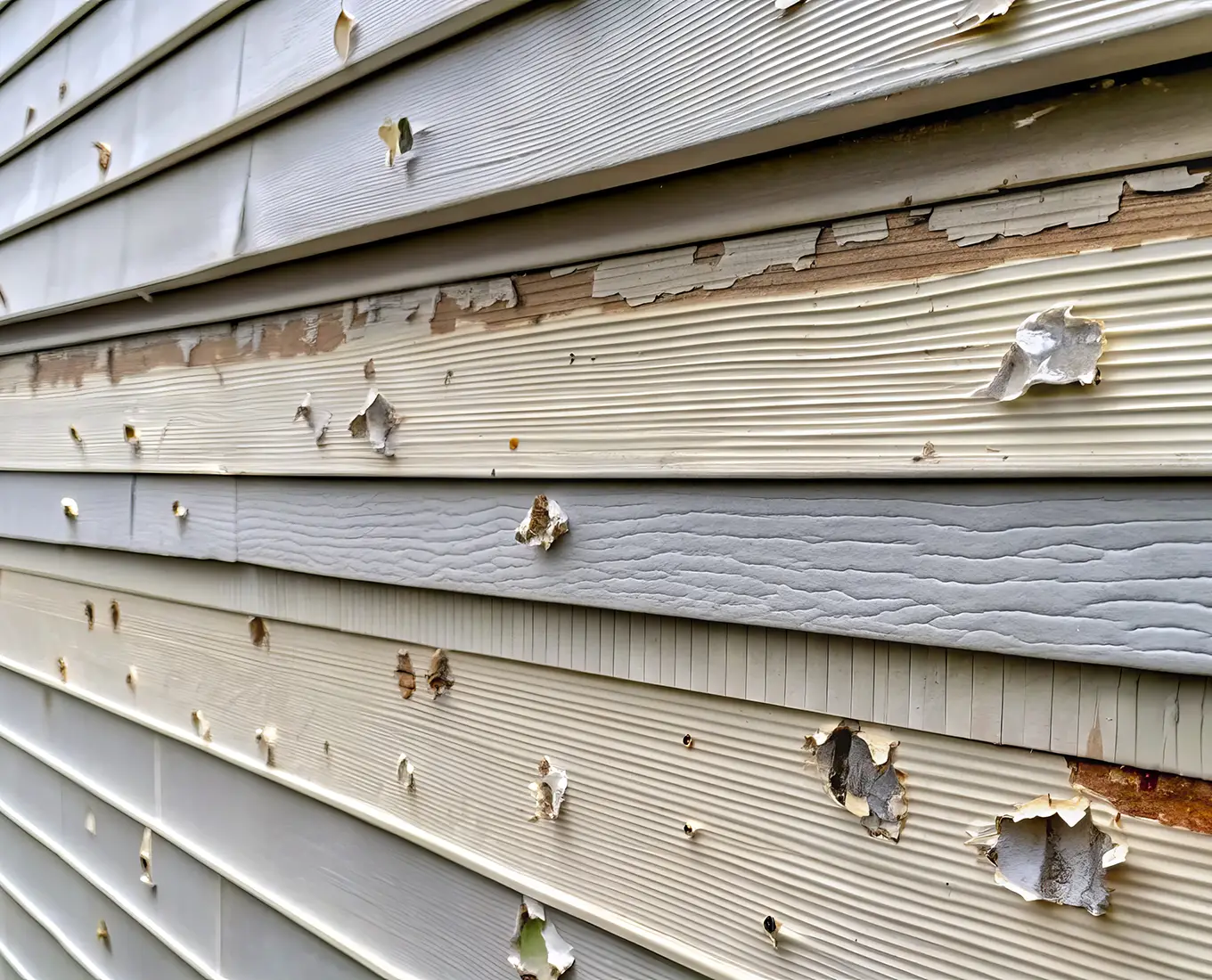 hail-damaged siding on a residential exterior in st louis mo