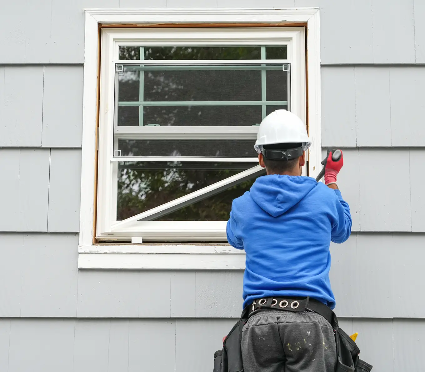 contractor working on replacing the window of the house in st louis mo