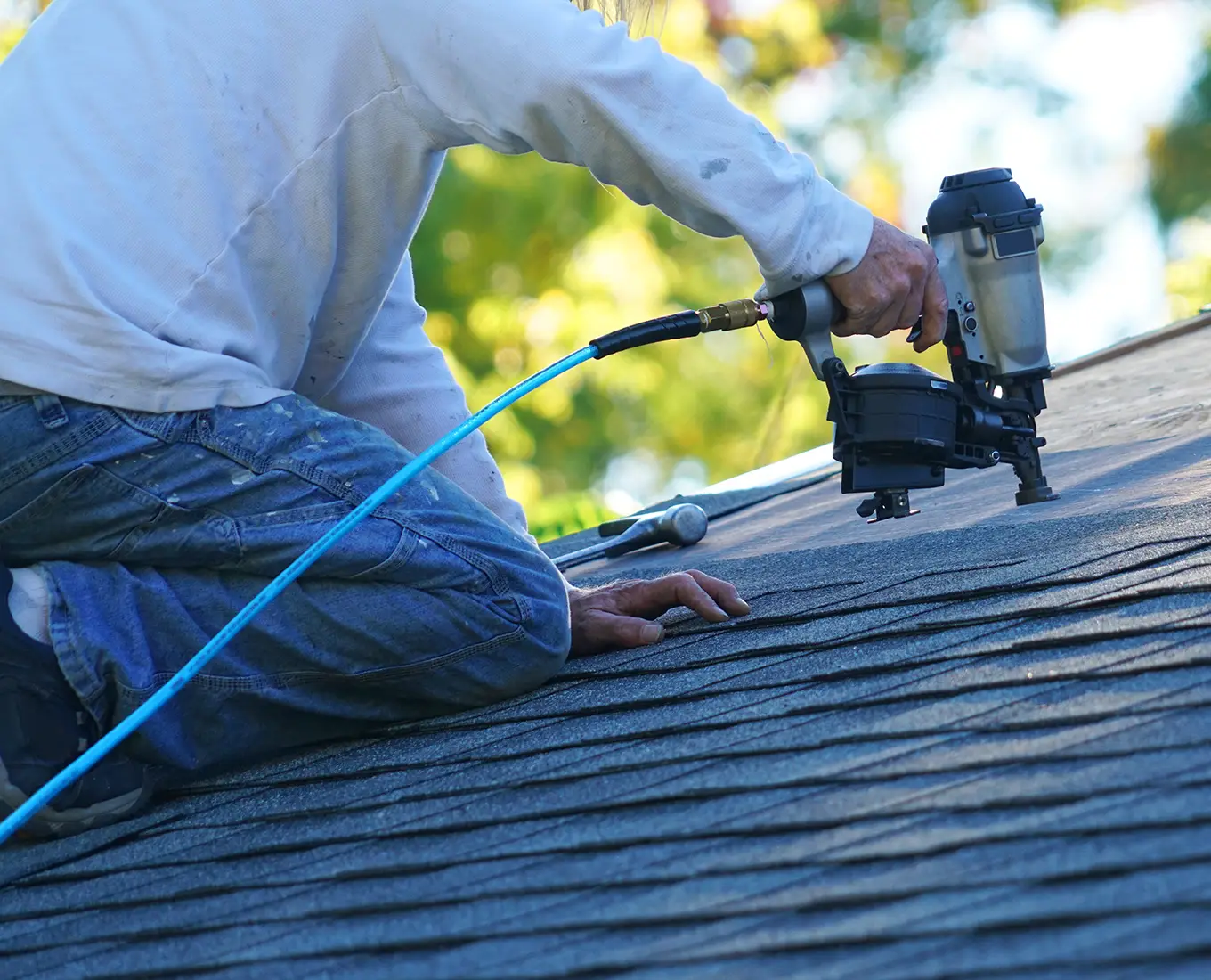 roofer adding shingles to roof for roof repair in st louis mo