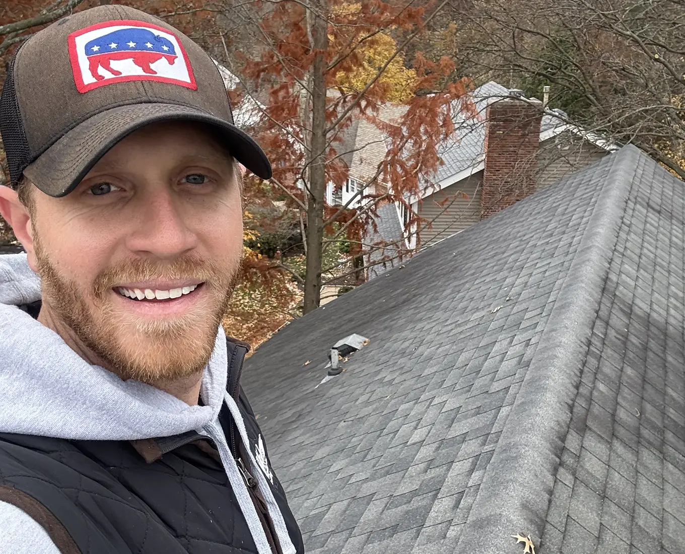 tanner on top of roof working on roof repair in st. louis mo