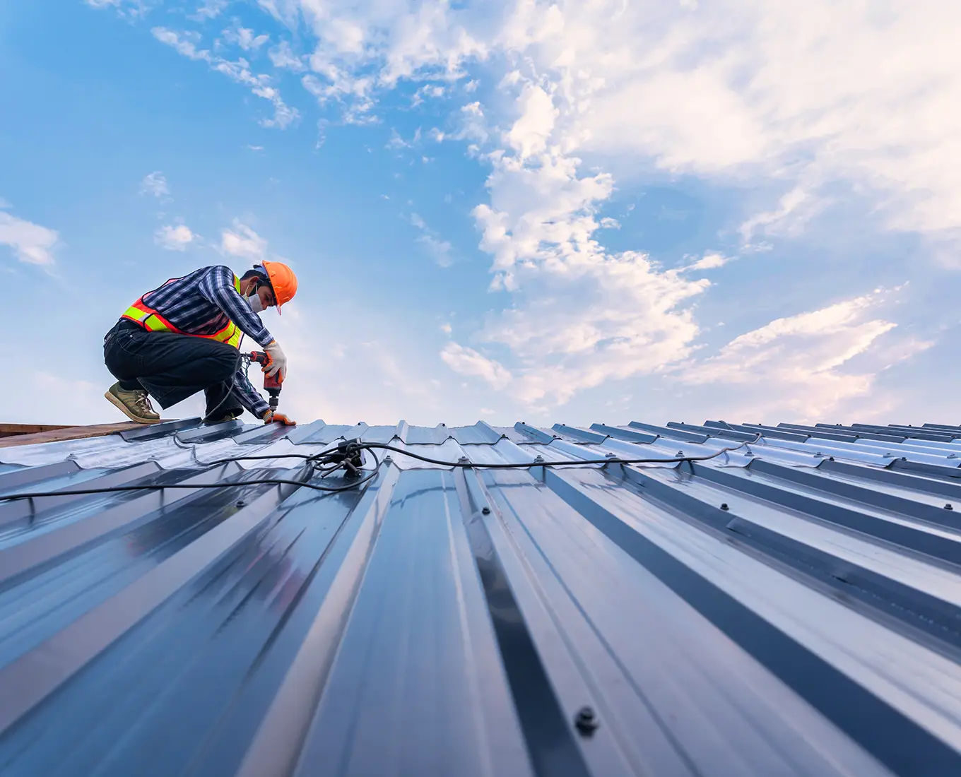 Roofer installing on new roof metal sheet on roof in st louis mo