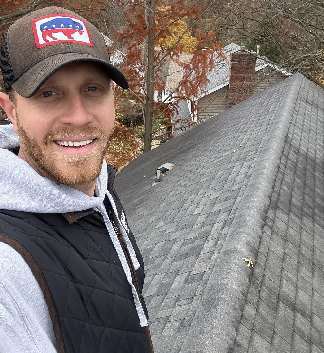 tanner on top of roof working on roof repair in st. louis mo