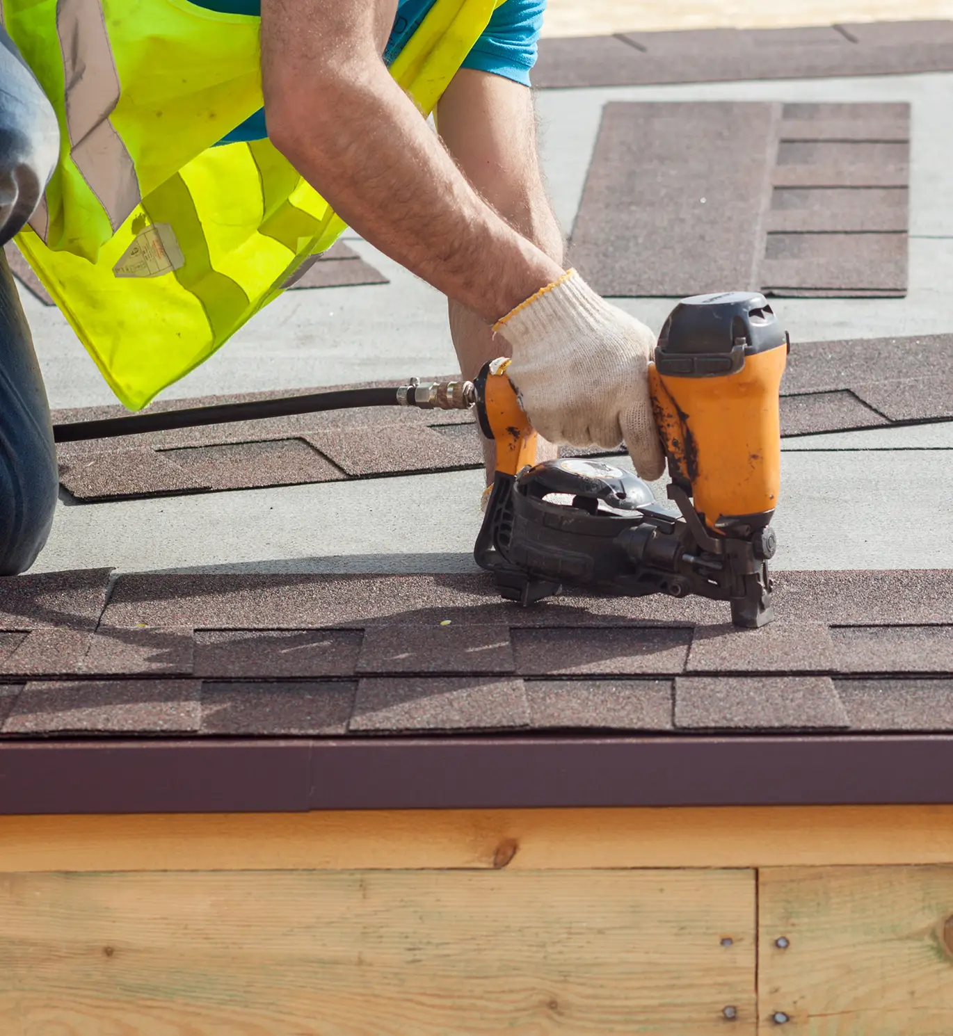 roofer installing new roof shingles on residential house in st louis mo