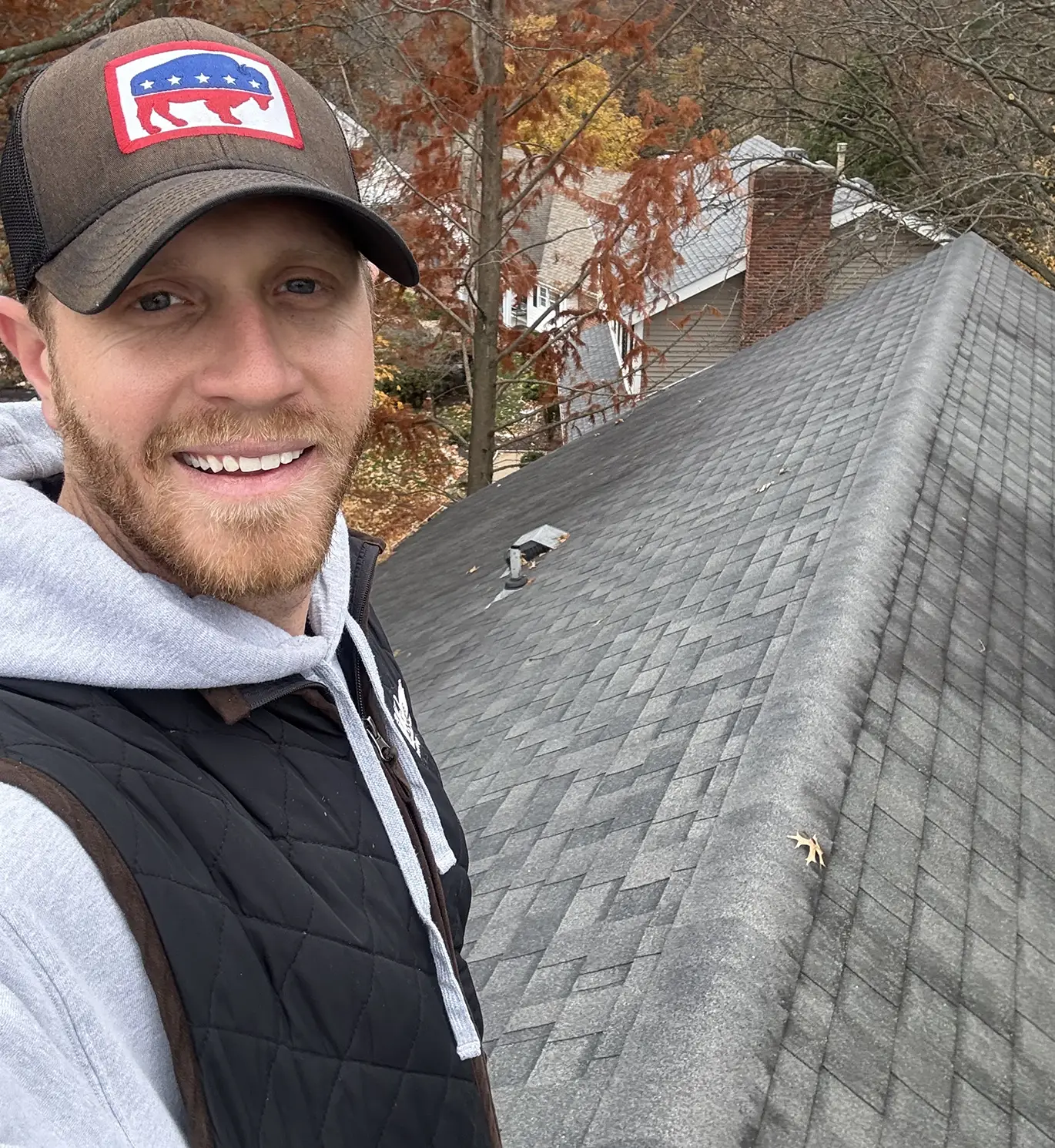 tanner on top of roof working on roof repair in st. louis mo