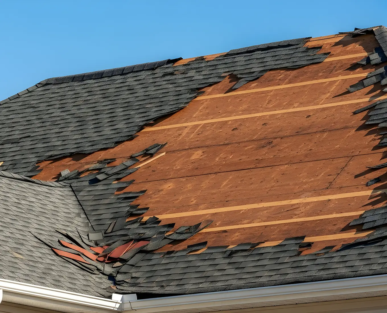 emergency Roof Repair: Severe Storm Damage with Missing Shingles and Exposed Plywood - st louis mo