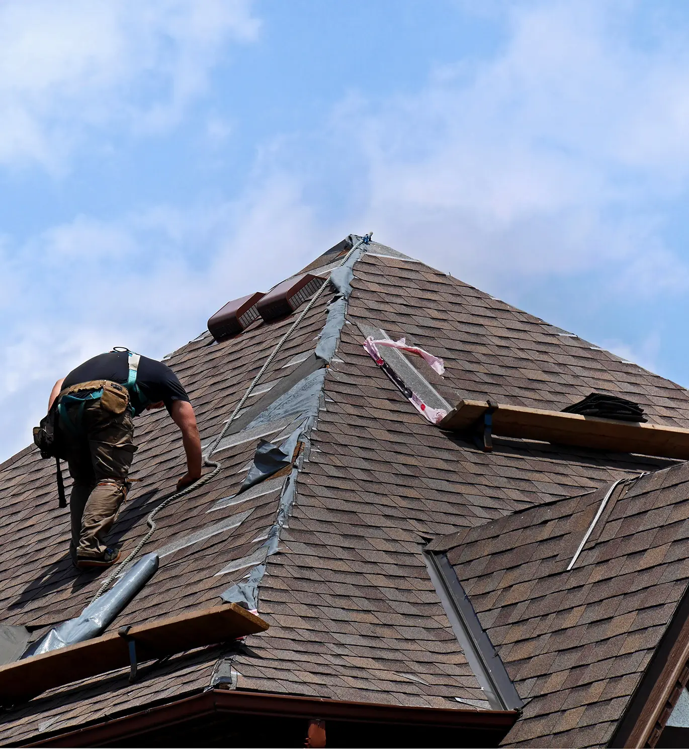 roofer on roof working on roof repair in st louis mo
