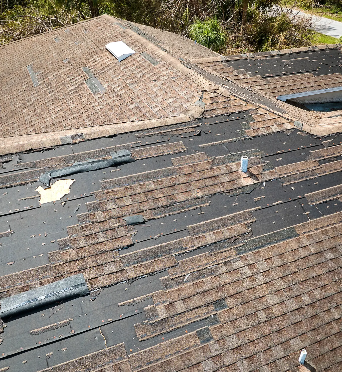 house roof with missing shingles and storm damage in st louis mo