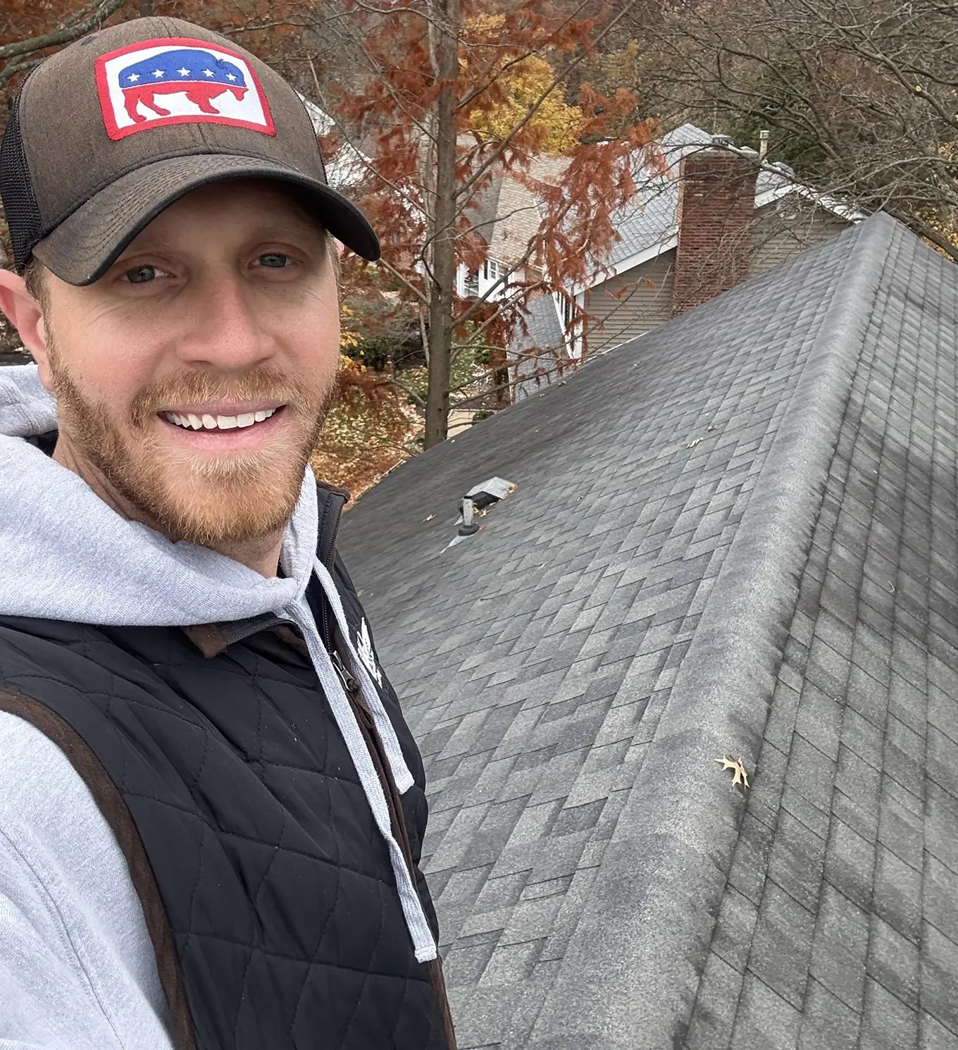 tanner on top of roof working on roof repair in st. louis mo