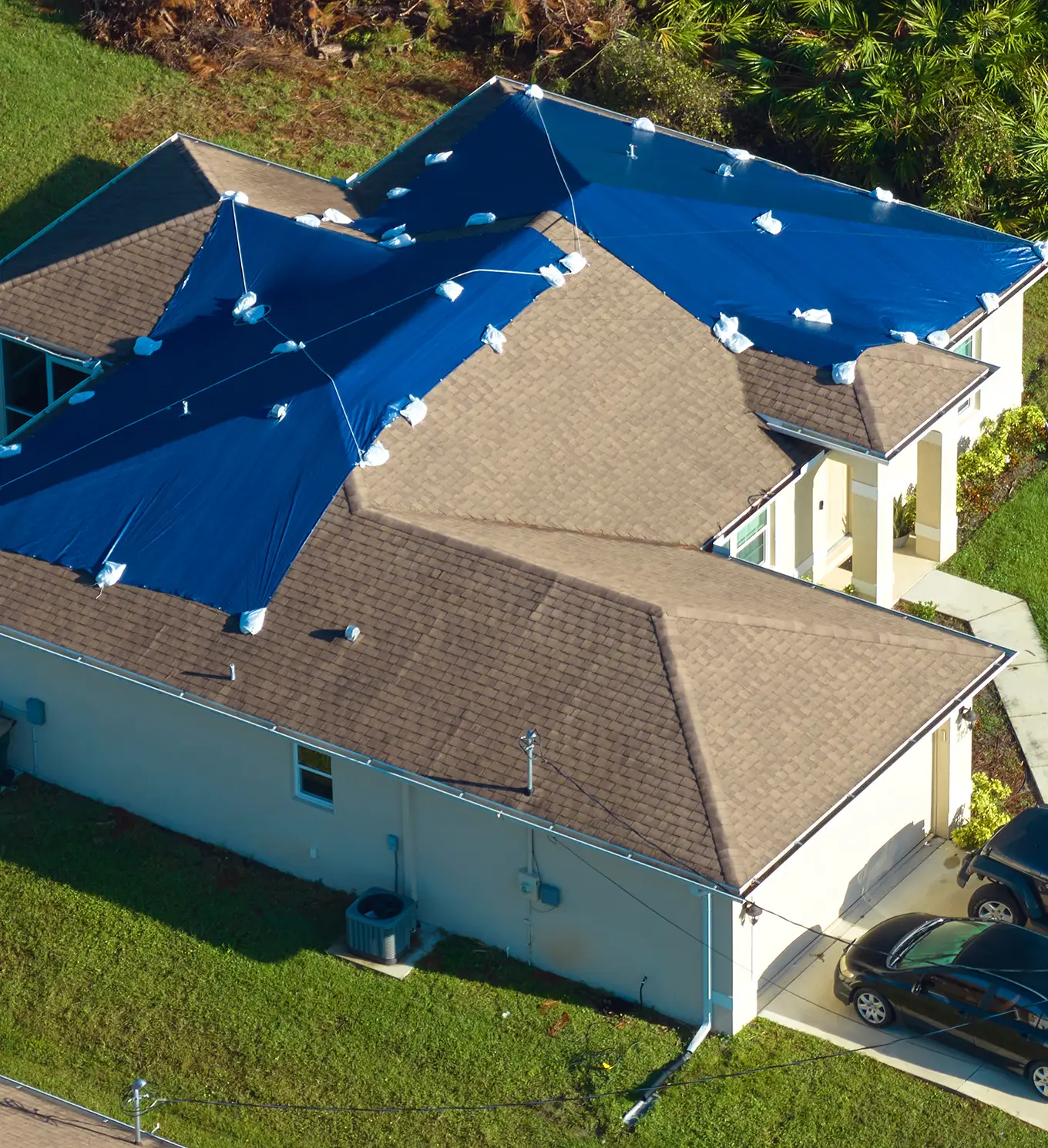 house roof covered with blue protective tarp in st louis mo