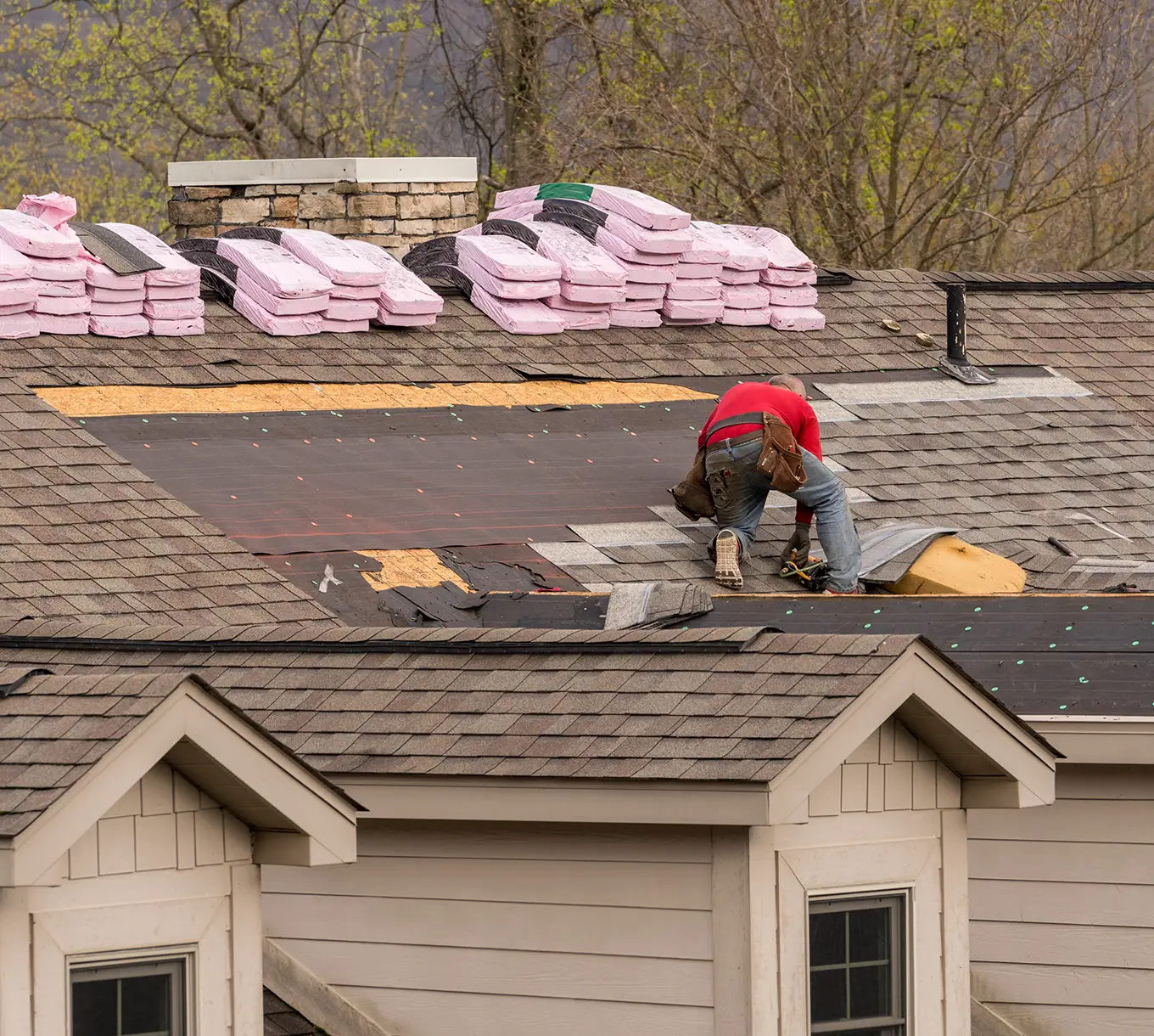 Roofing contractor removing the old tiles before replacing with new shingles on a townhouse roof in ballwin mo