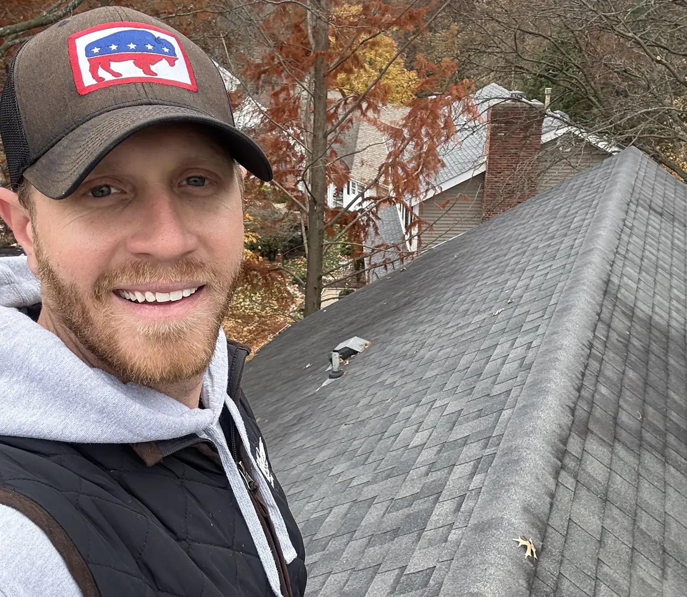 tanner on top of roof working on roof repair in st. louis mo